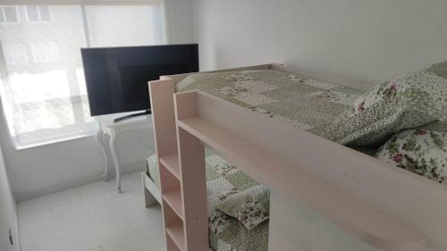 a bedroom with a bunk bed and a television at DEPTO SUITE II in Iquique