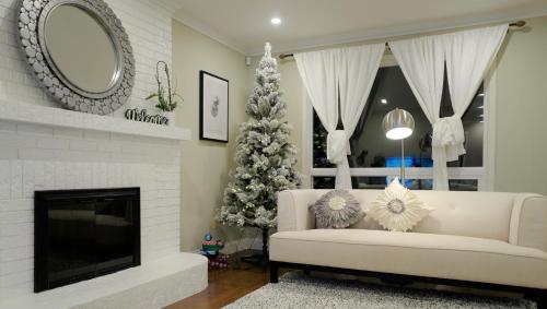 a living room with a christmas tree and a white couch at Le Boutique Great Toronto in Mississauga