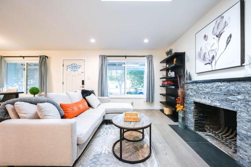 a living room with a couch and a fireplace at @ Marbella Lane - Exquisite Home 3BR in Sunnyvale