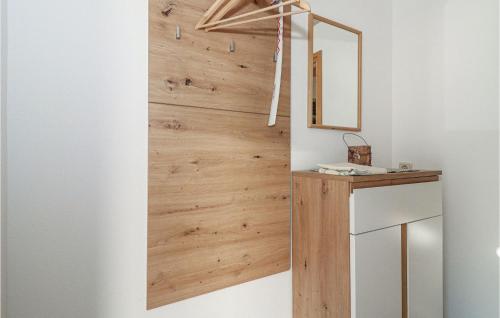 a wooden wall in a bathroom with a mirror at Lovely Apartment In Dalaas Wald With Wifi in Ausserwald