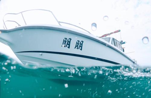 a boat sitting in the water in the ocean at Meet Bay B&B in Xiyu