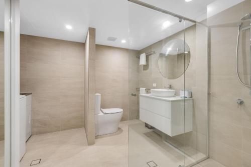 a bathroom with a toilet and a sink and a shower at San Chelsea 8 in Gold Coast