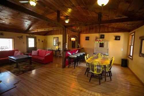 a living room with a table and chairs at Climb On Inn - Red River Gorge Kentucky - Amazing Home ! 