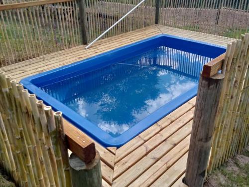 a swimming pool on a wooden deck with a fence at Cango's Rest in Oudtshoorn
