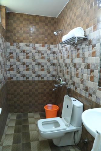 a bathroom with a toilet and a sink at CHRISTIAN GUEST HOUSE in Vellore