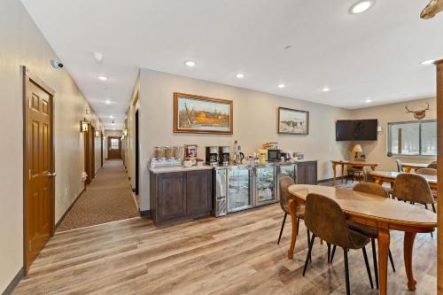 a living room with a table and a kitchen at Wagon Wheel Hotel in West Yellowstone