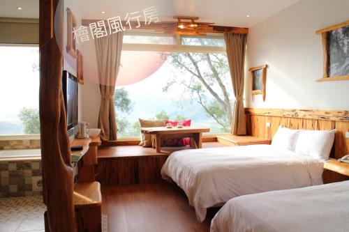 a hotel room with two beds and a window at Shangrila Leisure Farm in Dongshan