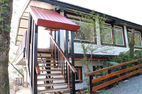 a house with a staircase leading up to it at Shangrila Leisure Farm in Dongshan