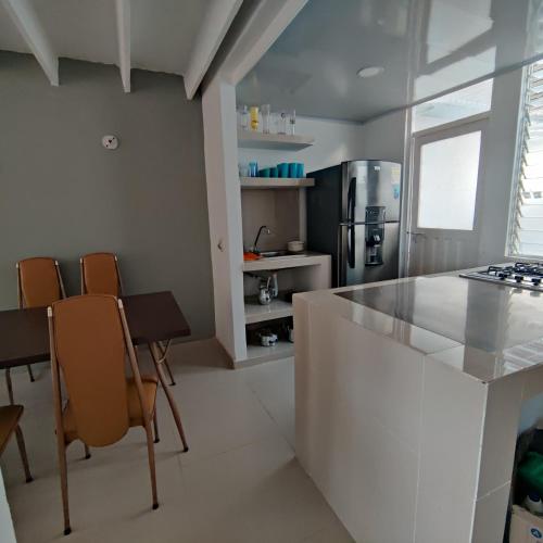 a kitchen with a counter and chairs in a room at Conjunto Buganviles - Casa No 7 o 3 in Girardot