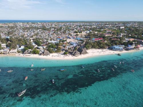 an aerial view of a beach with boats in the water at Siri Beach Lodge in Nungwi