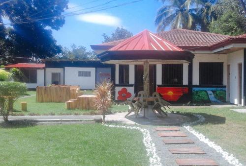 a small house with a gazebo in the yard at RedDoorz @ Golden Travellers Inn Antique in Hamtic