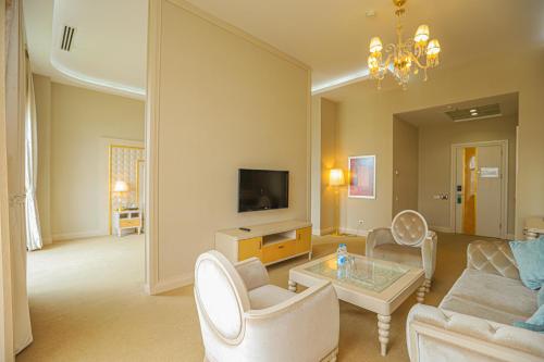 a living room with a couch and a table at Gabala Garden Hotel in Gabala