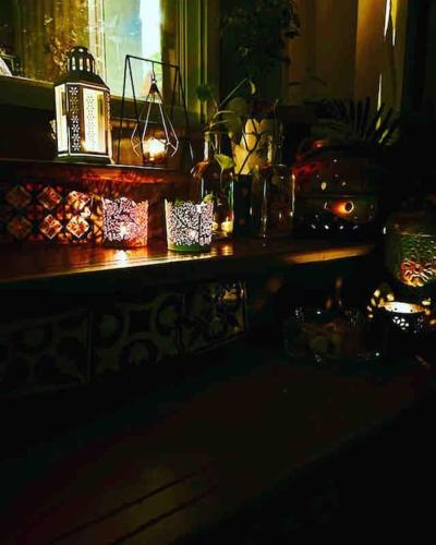 a dark room with a wooden table with a window at The Silver Lining - 2 bhk Villa facing the hills in Karjat