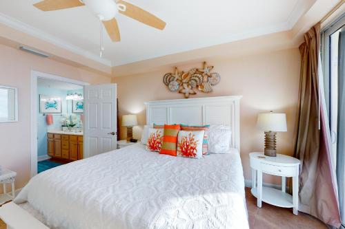 a bedroom with a white bed and a ceiling fan at Harbour Pointe 703 in Perdido Key