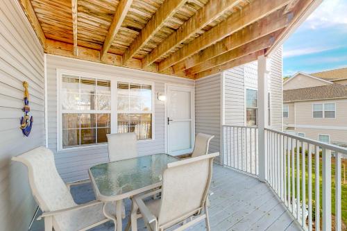 a patio with a table and chairs on a balcony at Bethany Bay --- 37514 Pettinaro Dr # 9404 in Ocean View