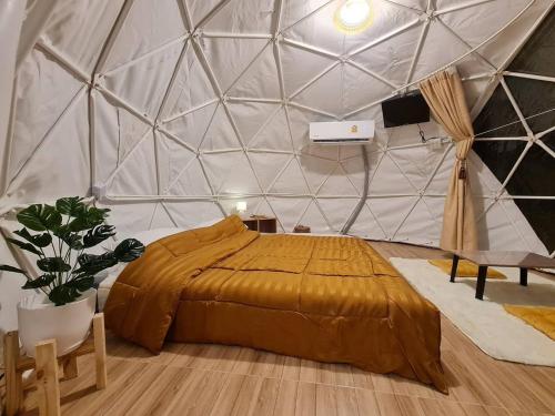 a bedroom with a bed in a tent at SB Inn in Phetchaburi