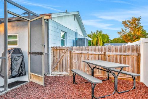 a patio with a picnic table and a fence at Blue on Fox Run in Apollo Beach