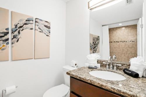 a bathroom with a sink and a toilet at Blue on Fox Run in Apollo Beach