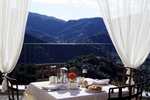 a table with food and flowers on top of a balcony at Agriturismo Costa di Faraggiana in Levanto