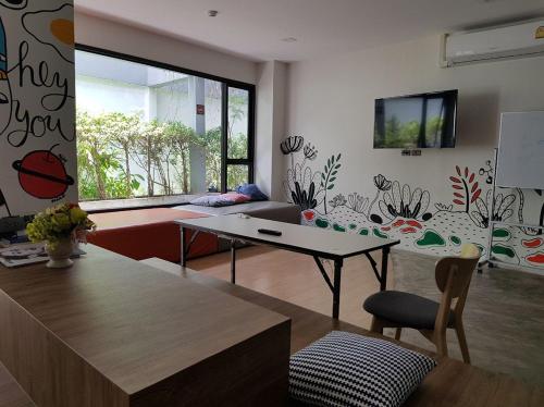 a living room with a table and a couch at All day hostel at BTS Bang Chak in Bangkok