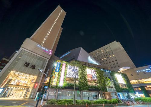 um grande edifício com luzes à frente à noite em Ours Inn Hankyu em Tóquio