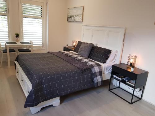 1 dormitorio con 1 cama y 1 mesa con lámparas en Hampton on Washington - FREE Wifi and Netflix en Goolwa