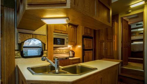 a kitchen in an rv with a sink at Sunyang Village Dome Caravan in Jeju