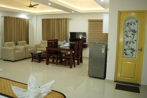 a living room with a kitchen and a dining room at RJ ROSS RAMAPURAM in Munnar