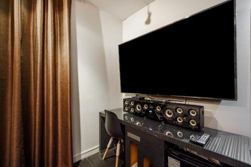 a flat screen tv sitting on top of a table at Laria Hotel in Suwon
