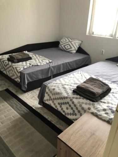 a room with two beds and a window at Centre apartment in Prilep