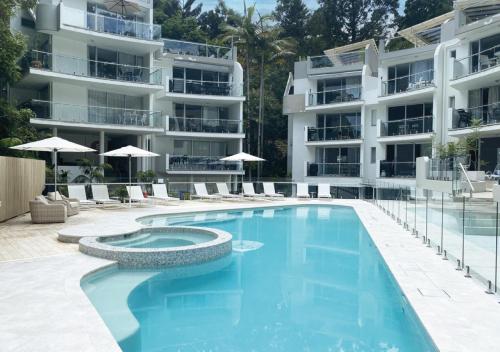 an image of a swimming pool in front of a building at The Cove Noosa - Apartment 4 in Noosa Heads
