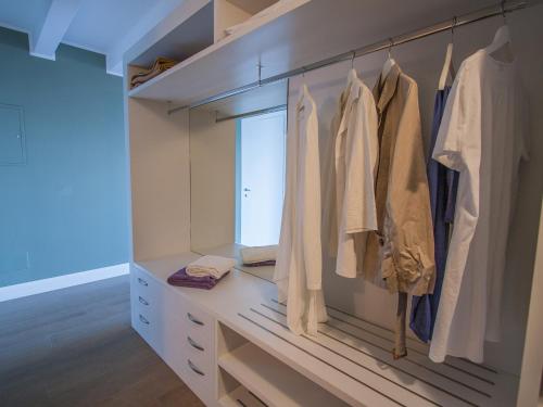 a walk in closet with white clothes on racks at Borgo Le Terrazze in Bellagio