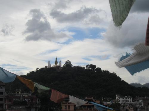 a view of a city with flags flying in the sky at STUPA VIEW INN in Kathmandu