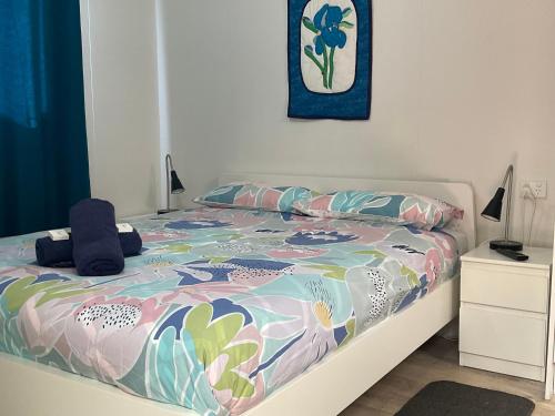 a bedroom with a bed with a colorful comforter at Leander Reef Holiday Park in Port Denison