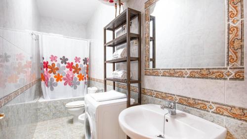 a bathroom with a sink and a toilet and a mirror at Casas María Carmona - Casa Luna Níjar by Ruralidays in Níjar