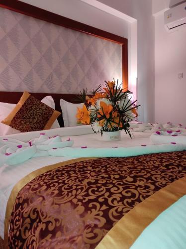 a bedroom with a large bed with flowers on it at Aquavista Hotel & Suites in Aqaba
