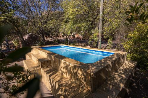 a swimming pool with a stone wall around it at Wolfkop Nature Reserve in Citrusdal