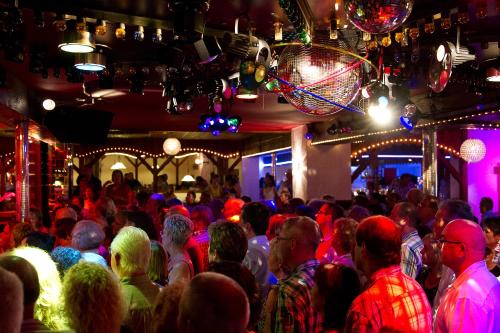 a crowd of people at a party in a bar at Gasthaus zur Grässelmühle in Sasbach in der Ortenau