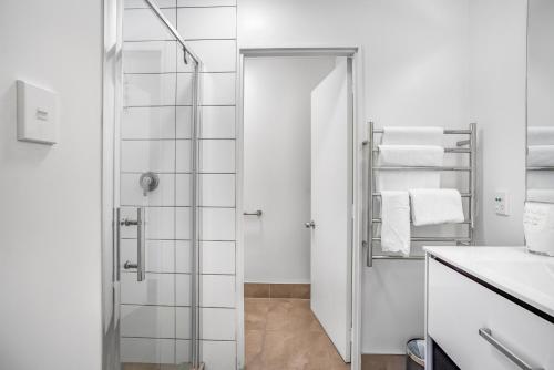 a bathroom with a shower and a glass door at Capital Lodge Motor Inn in Wellington