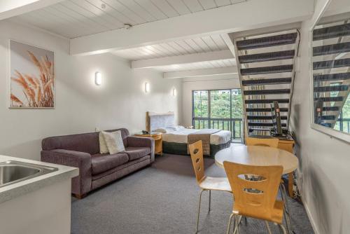 a living room with a couch and a table at Capital Lodge Motor Inn in Wellington
