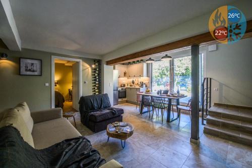 a living room with a couch and a table at Garden Cellar - Kalamata Mediterranean Villas in Kalamata