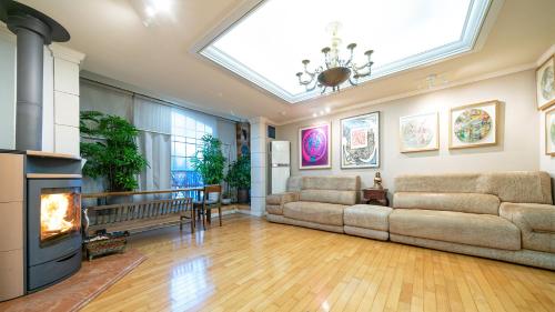 a living room with a couch and a fireplace at Museum Stay in Yongin