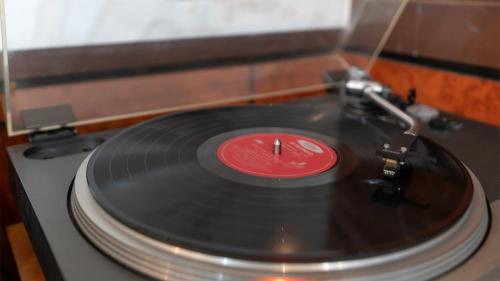 a red vinyl record sitting on top of a table at Museum Stay in Yongin