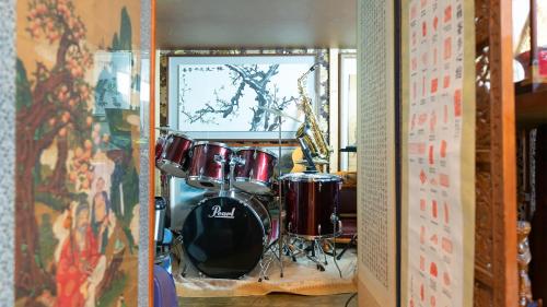 a room with a drum set on a shelf at Museum Stay in Yongin