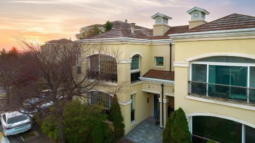 a large yellow house with a roof at Museum Stay in Yongin