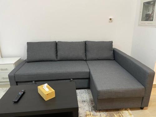 a gray couch in a living room with a coffee table at ZAPBED House - Luxury Holiday Homes in Yas Island in Abu Dhabi