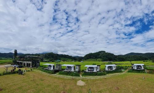an aerial view of a group of tents in a field at WC Coffee&ไร่หวานซึ้ง in Mae Hong Son