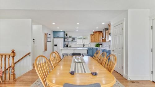 a kitchen and dining room with a wooden table and chairs at Play & Gather in Luxury,Pets too! Close to it Everything! in Orem