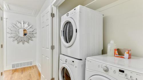 a white laundry room with a washer and dryer at Play & Gather in Luxury,Pets too! Close to it Everything! in Orem