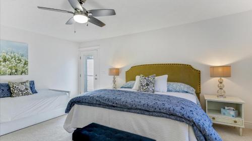 a bedroom with a bed and a ceiling fan at Play & Gather in Luxury,Pets too! Close to it Everything! in Orem